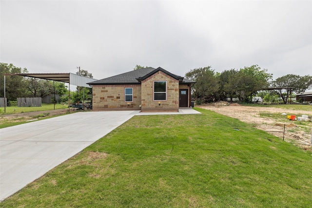 view of front facade with a carport and a front lawn