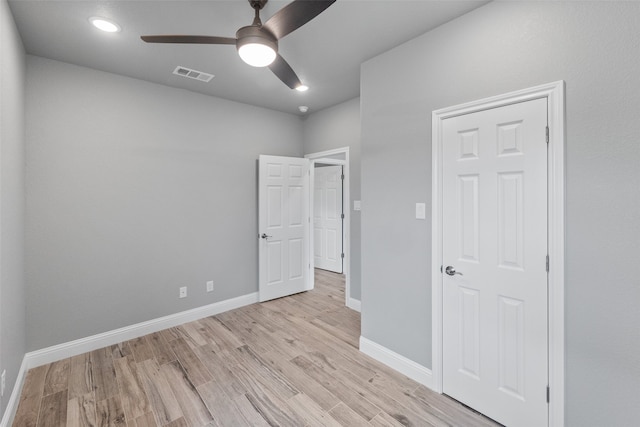 unfurnished bedroom featuring light wood-type flooring and ceiling fan