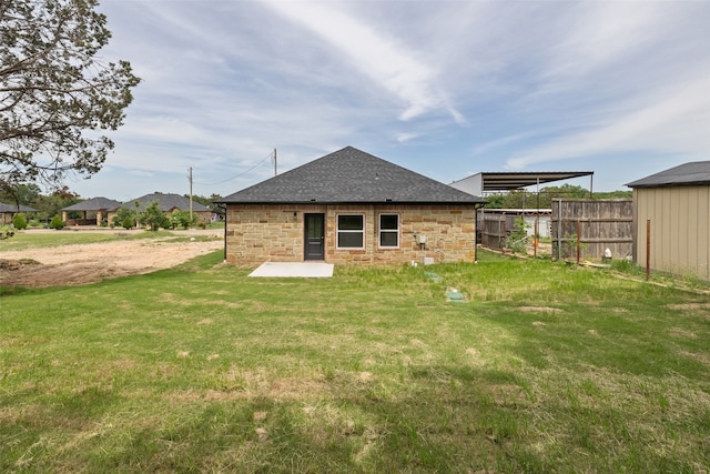 back of house with a lawn and a patio area