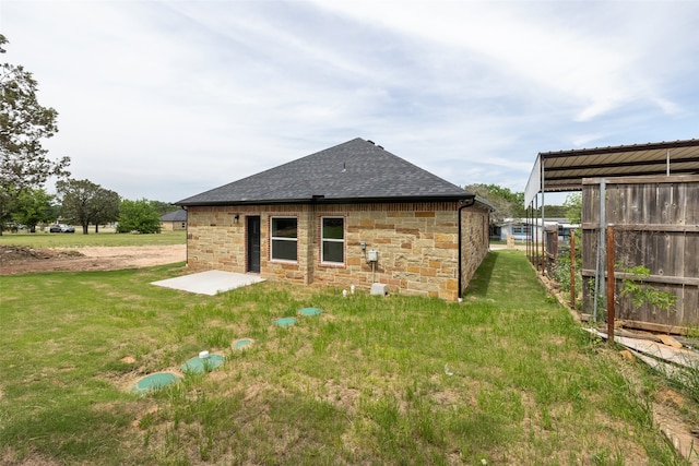 rear view of property with a lawn