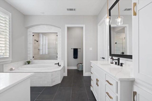 bathroom featuring tile patterned flooring, vanity, and separate shower and tub