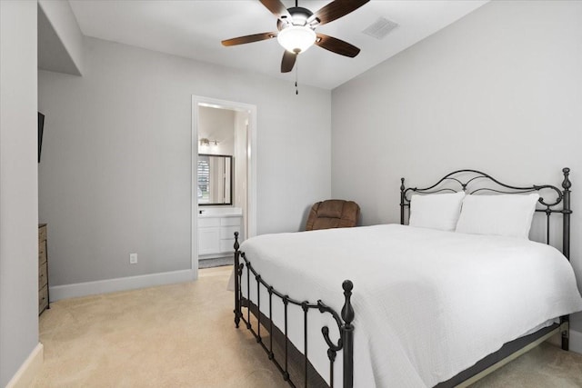 carpeted bedroom with ceiling fan and ensuite bathroom