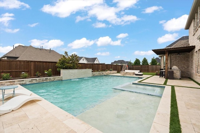 view of swimming pool featuring a patio, pool water feature, and area for grilling