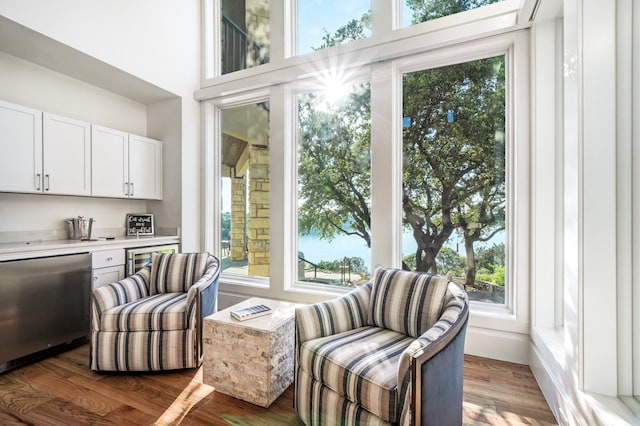 living area with plenty of natural light and light hardwood / wood-style flooring