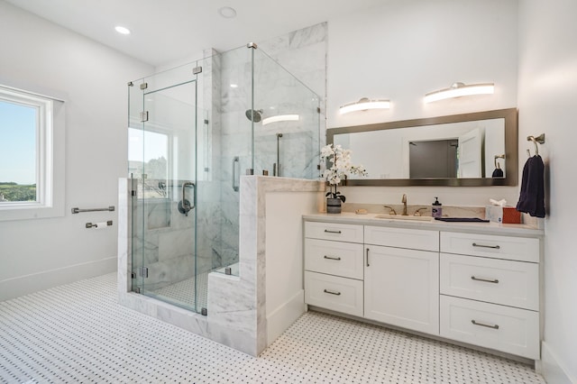 bathroom with tile patterned floors, vanity, and a shower with door