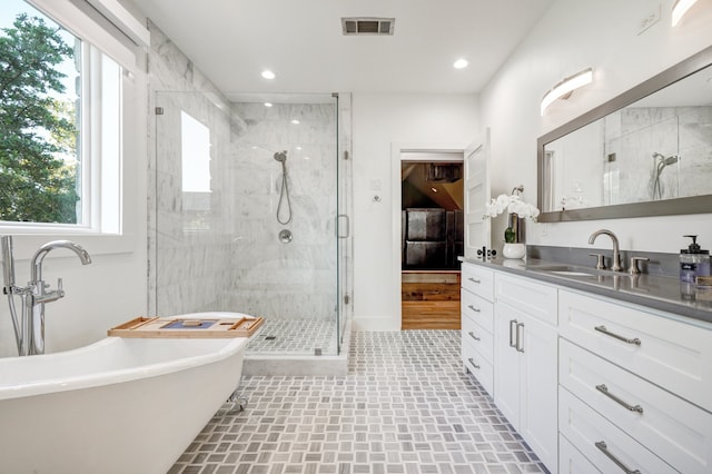 bathroom featuring vanity, tile patterned flooring, and shower with separate bathtub