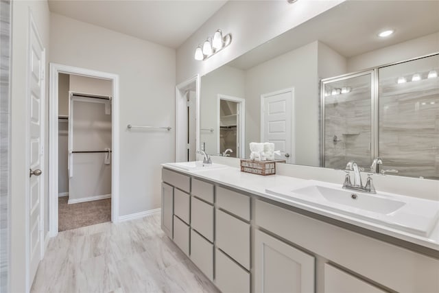 bathroom featuring walk in shower and vanity