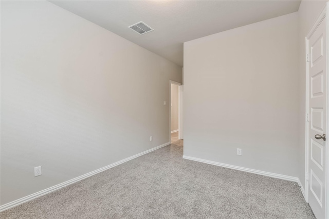 empty room featuring visible vents, baseboards, and carpet floors