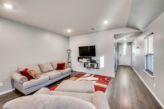 living room with dark wood-type flooring and lofted ceiling