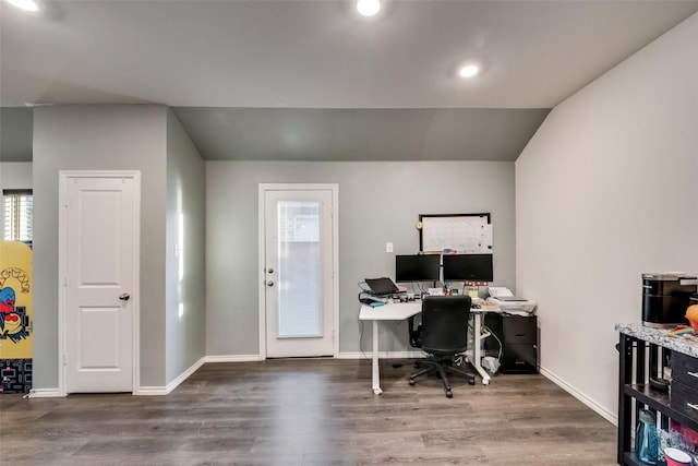 office space featuring vaulted ceiling and hardwood / wood-style flooring