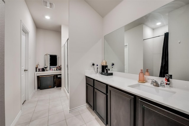 bathroom with an enclosed shower, tile flooring, and vanity