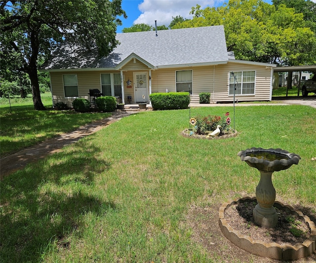 ranch-style house featuring a carport and a front yard