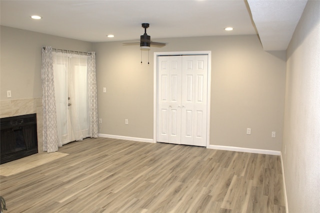 unfurnished living room with light wood-type flooring and ceiling fan