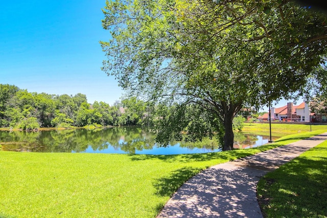 view of home's community featuring a water view and a yard