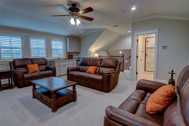 living room with ornamental molding, ceiling fan, vaulted ceiling, and light colored carpet