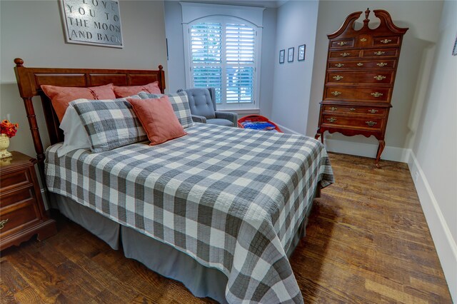 bedroom featuring dark hardwood / wood-style flooring