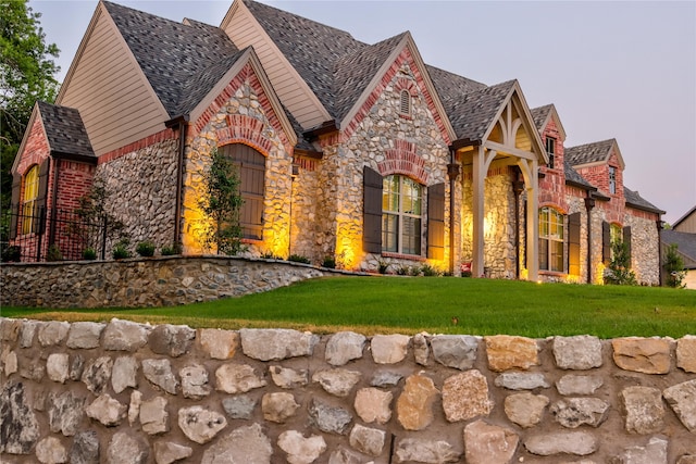 tudor-style house with a front lawn