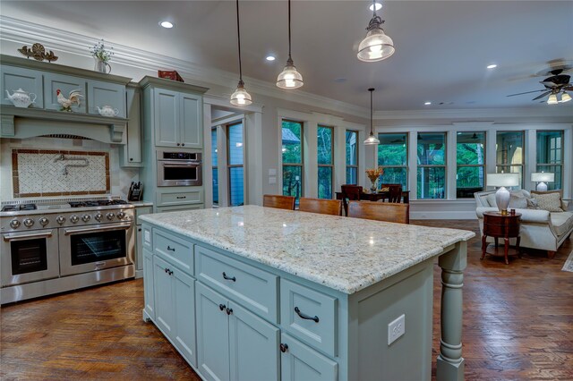 kitchen with a center island, dark hardwood / wood-style flooring, stainless steel appliances, decorative light fixtures, and backsplash