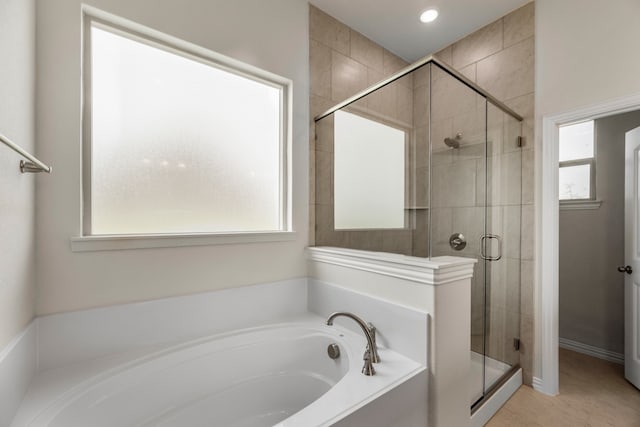 bathroom featuring tile patterned flooring and plus walk in shower