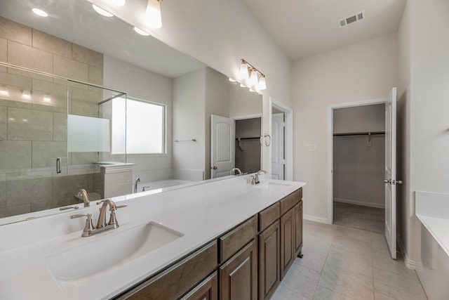 bathroom with vanity, shower with separate bathtub, and tile patterned floors