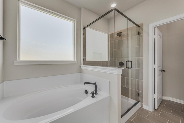 bathroom featuring a garden tub, recessed lighting, a shower stall, baseboards, and tile patterned floors