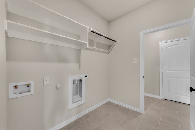 laundry area featuring gas dryer hookup, light tile patterned flooring, electric dryer hookup, and washer hookup