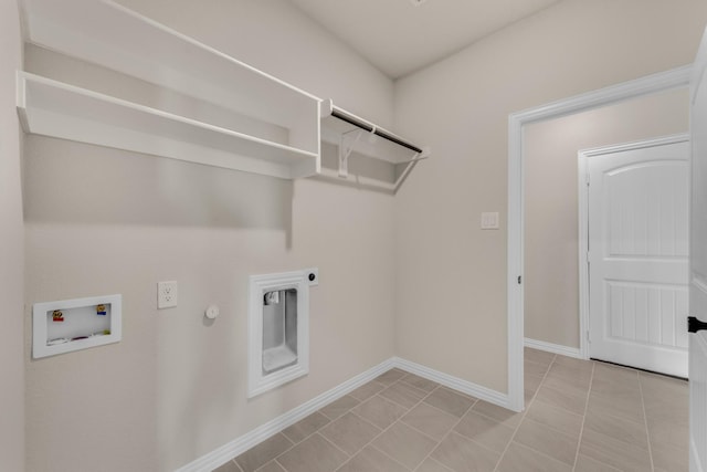 clothes washing area featuring hookup for a washing machine, hookup for a gas dryer, hookup for an electric dryer, laundry area, and baseboards