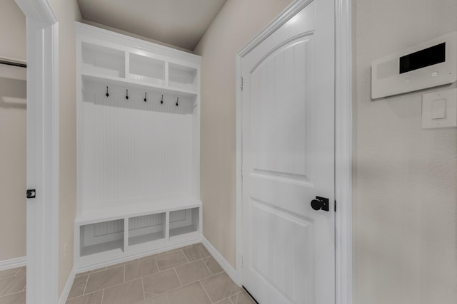 mudroom with light tile patterned floors and baseboards