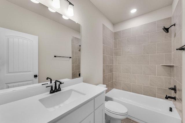 bathroom with tub / shower combination, vanity, and toilet