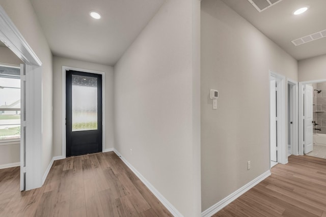 entrance foyer with light wood-style flooring, recessed lighting, visible vents, and baseboards