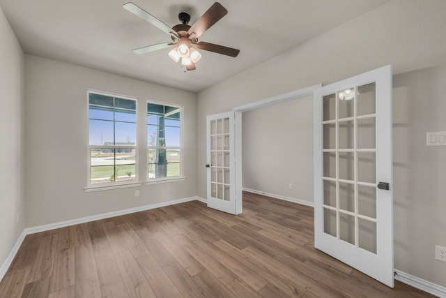 unfurnished room featuring french doors, hardwood / wood-style floors, and ceiling fan