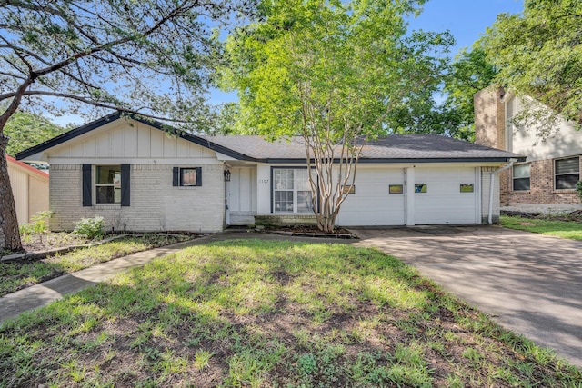 single story home with a garage and a front lawn