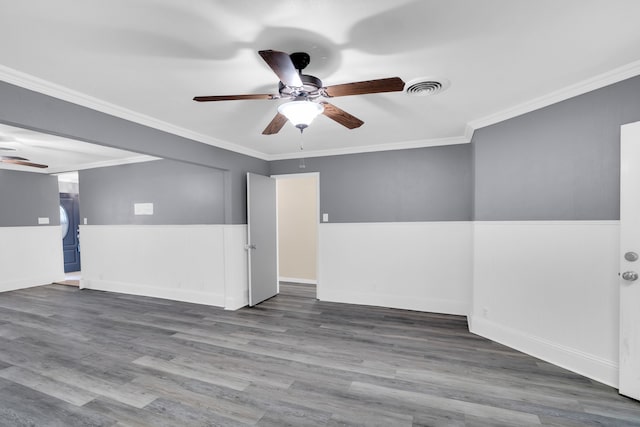 unfurnished room featuring crown molding, wood-type flooring, and ceiling fan