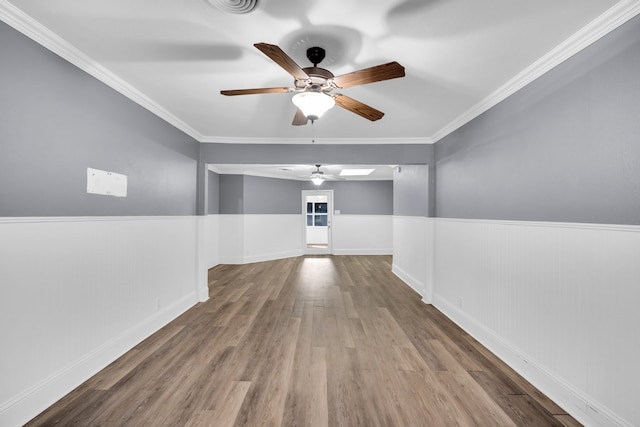 spare room with crown molding, ceiling fan, and hardwood / wood-style floors