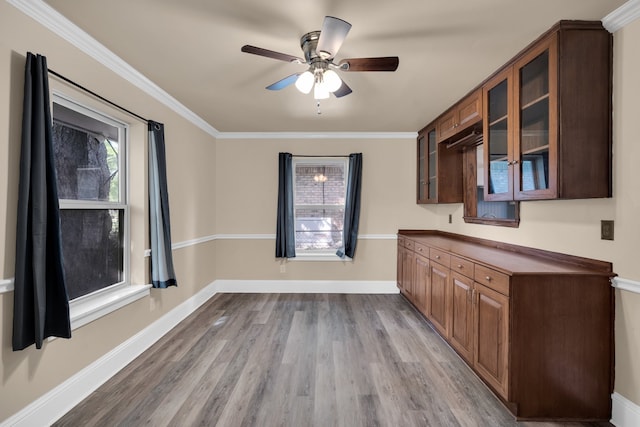 kitchen with crown molding, hardwood / wood-style flooring, and ceiling fan