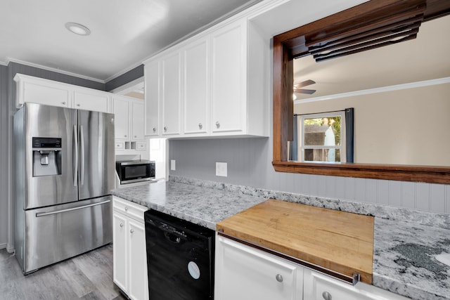 kitchen featuring stainless steel appliances, white cabinets, ornamental molding, and light wood-type flooring