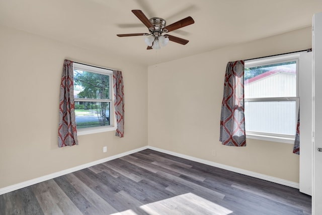 spare room with dark hardwood / wood-style floors and ceiling fan