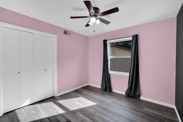 unfurnished bedroom featuring wood-type flooring, a closet, and ceiling fan