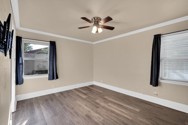 empty room with dark wood-type flooring, ornamental molding, and ceiling fan