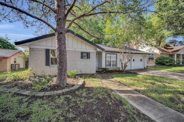 single story home featuring a front lawn and a garage