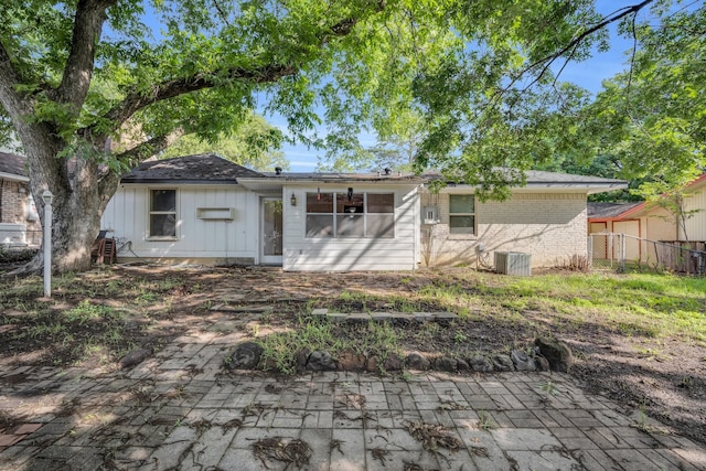 rear view of house with central AC and a patio area