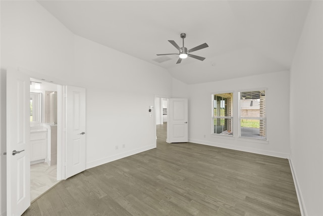 empty room featuring lofted ceiling, hardwood / wood-style floors, and ceiling fan