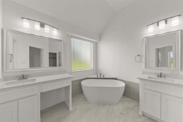 bathroom featuring a tub, tile patterned flooring, vaulted ceiling, and tile walls