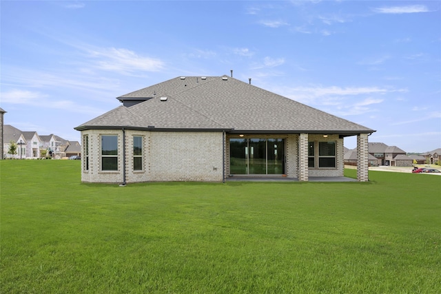 rear view of house with a patio area and a lawn