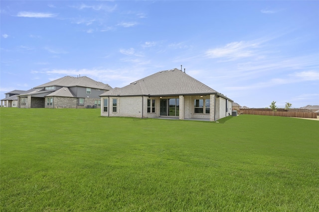 rear view of house featuring a lawn