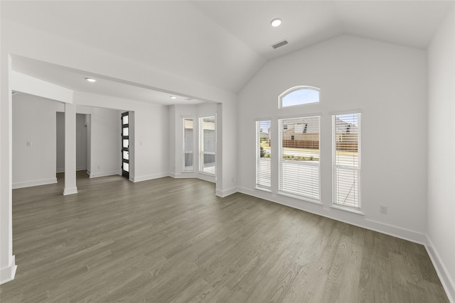 unfurnished living room with dark hardwood / wood-style flooring and lofted ceiling