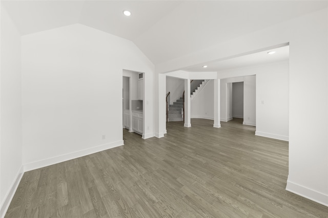 spare room with vaulted ceiling and hardwood / wood-style floors