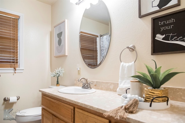 bathroom with vanity, tile patterned floors, and toilet