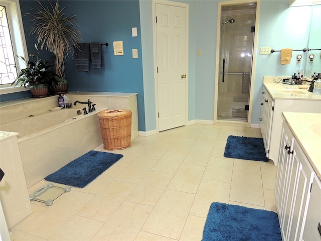 bathroom featuring tile flooring, separate shower and tub, and oversized vanity