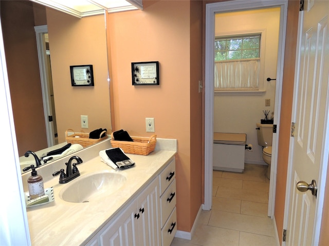 bathroom with vanity with extensive cabinet space, tile flooring, and toilet